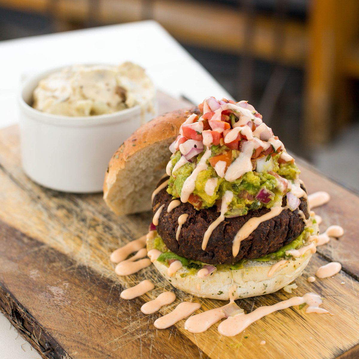 Black Bean Burger — House-made black bean patty, fresh guacamole, pico de gallo, sweet and spicy aioli served on toasted focaccia. Vegan and delicious. 💚
#hoptinger