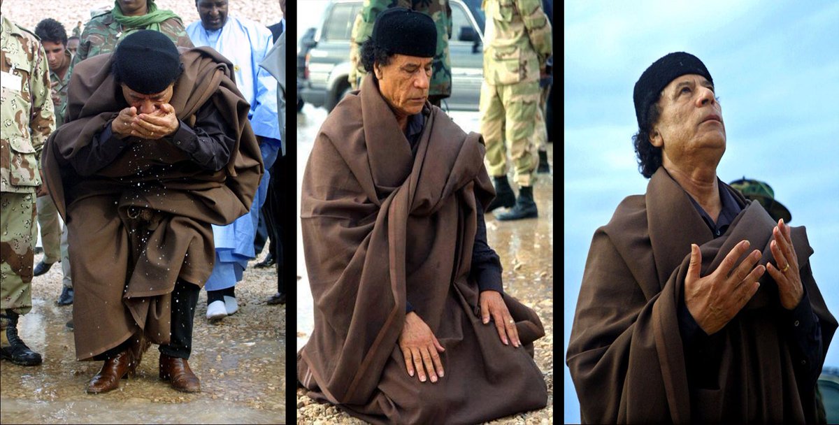 The leader Muammar Gaddafi prays to Allah and thanks Him for the blessing of the water he gave to the Libyan people, after the opening ceremony of the Gurdabiya dam, which is a phase of Libya's 'Great Man-Made River' water project, some 30 kms east of the city of Sirte.