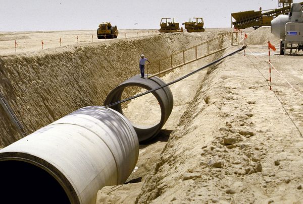 The leader Muammar Gaddafi prays to Allah and thanks Him for the blessing of the water he gave to the Libyan people, after the opening ceremony of the Gurdabiya dam, which is a phase of Libya's 'Great Man-Made River' water project, some 30 kms east of the city of Sirte.
