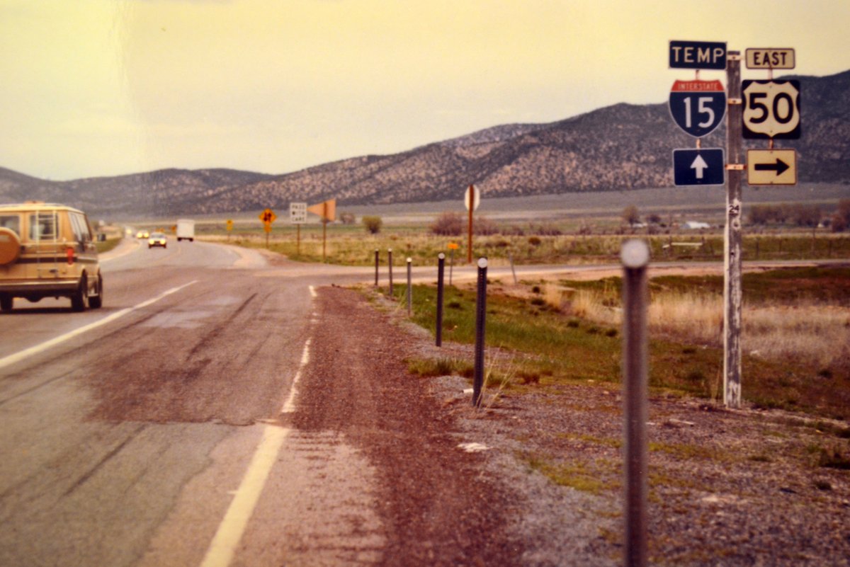 UtahDOT's tweet photo. Check out this #TBT of I-15 at U.S. 50 in Scipio, taken in 1983. This is the northern end of a newly opened section of I-15, where the interstate transitioned to U.S. 91 (designated “Temp I-15”). Note the two-way traffic! https://t.co/0DLZAxRrH8
