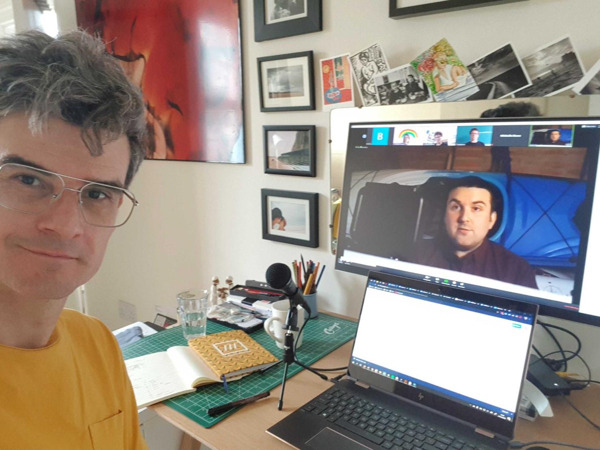 Creative Director Ivan sits at desk on zoom to other members of the team as they shoot campaign video remotely.