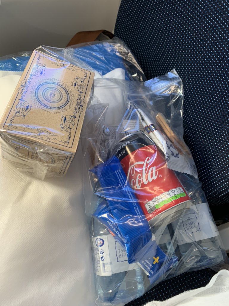 The purser has informed pax that the service has been radically modified; each pax has been given a bag with three small bottles of water, a soft drink, a sandwich, few cookies and two muesli bars. Plus we’ll get one hot meal.