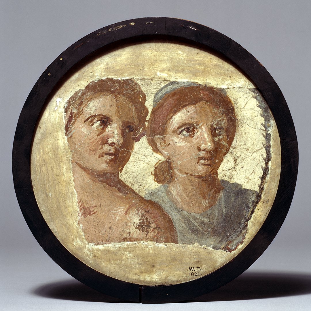 A wall painting showing a portrait of a man and a woman. The man is shown bare-chested and the woman is wearing a powder-blue tunic and a matching headband.