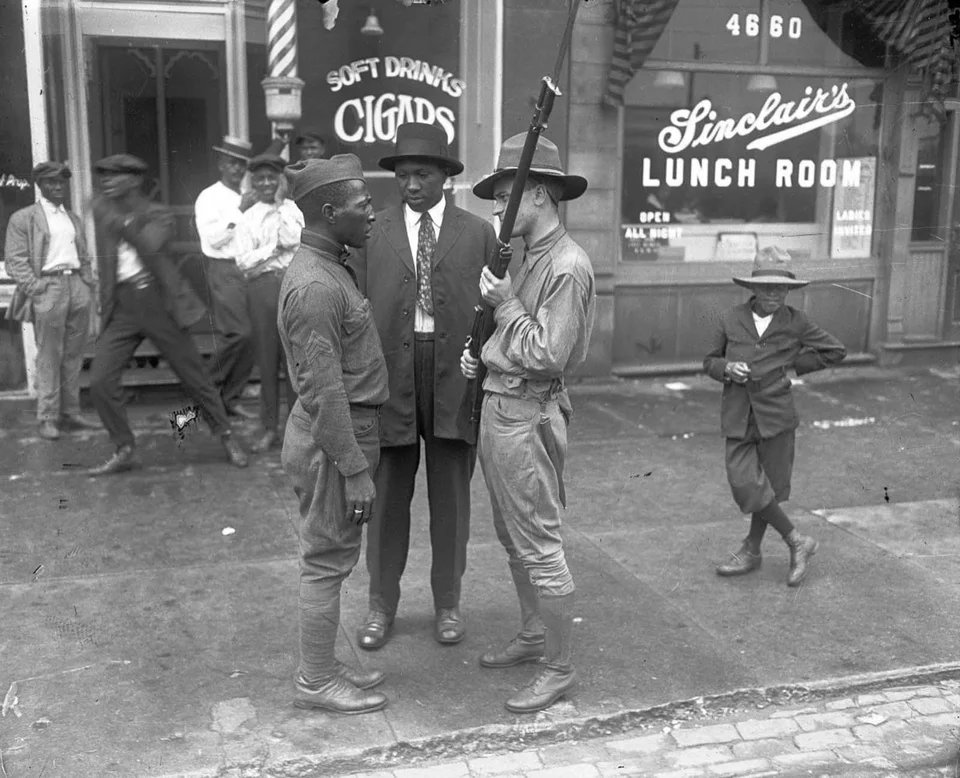 A member of the state militia faces off against an African-American veteran during the 1919 Chicago Race Riot. July 27, 1919.
