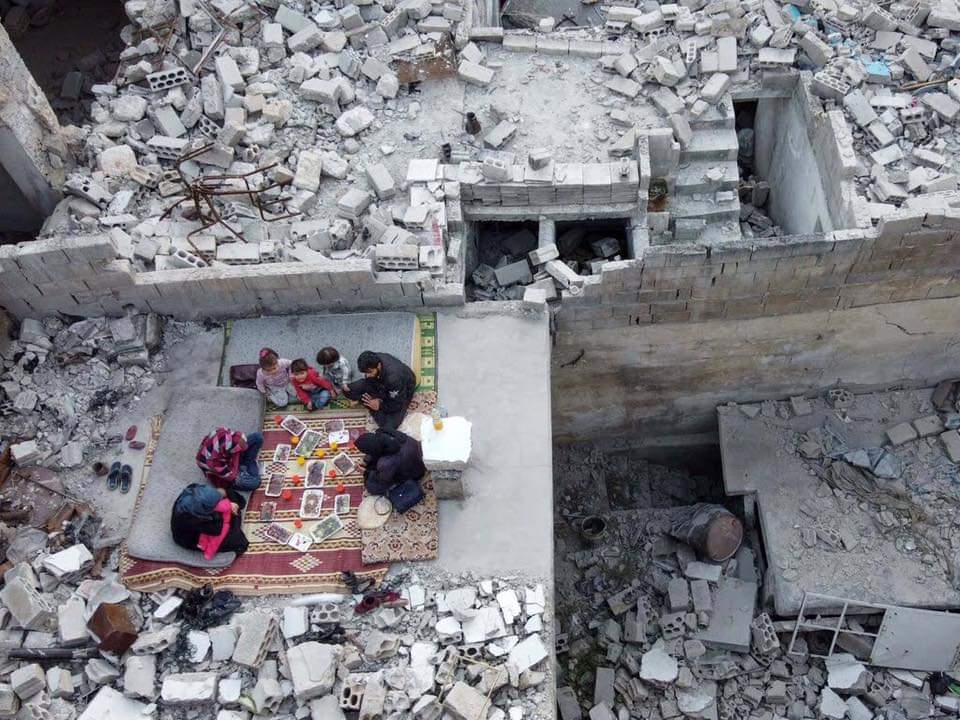abd_najd's tweet photo. Ramadan in the rubble. Family breaks bread where their home used to be. #LongLiveSyria https://t.co/GY80i6fW7j