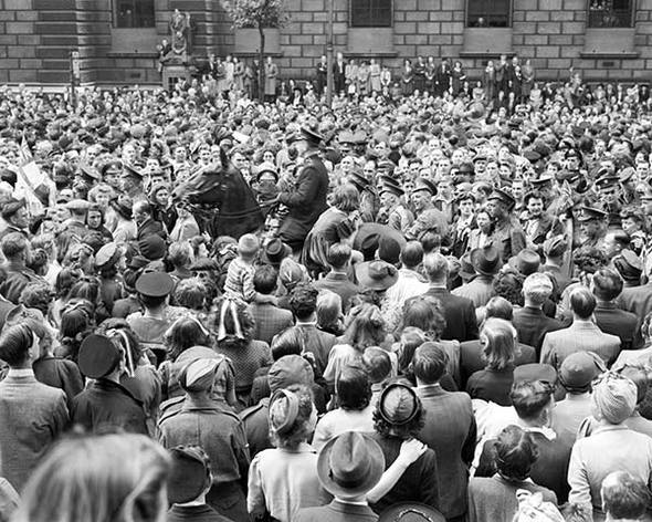 Through loudspeakers on Whitehall, the people heard the broadcast:‘Almost the whole world was combined against the evil-doers, who are now prostrate before us. Our gratitude to our splendid Allies goes forth from all our hearts in this Island and throughout the British Empire’