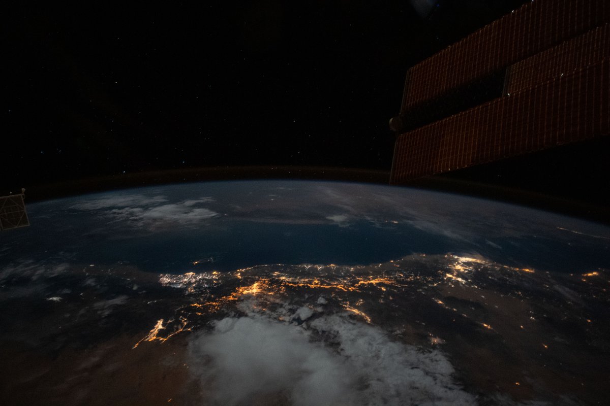 Space_Station's tweet image. The moonlit hues of Earth's terrain and seas glow dimly as city lights glitter on the Red Sea and Persian Gulf coasts. @NASA_Earth | flic.kr/s/aHsmACYoYM