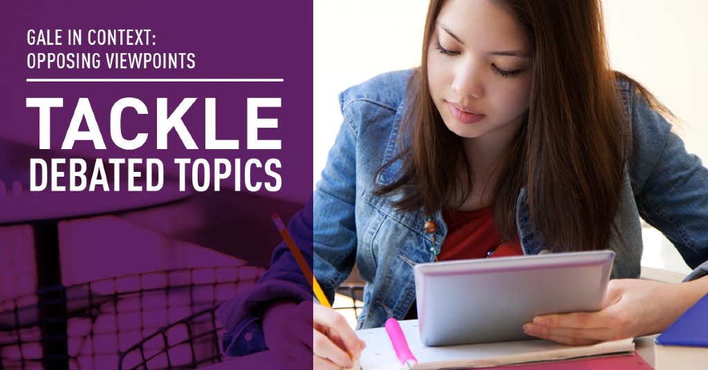a young teenage girl holding a notebook writing and looking down sitting at a desk
