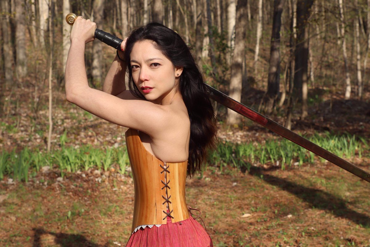 So I built this cedar strip corset out of scraps from building my canoe and I'm out on the backyard taking pictures and my aunt just walks out and hands me this sword and is like "looked like you needed this"She wasn't wrong.