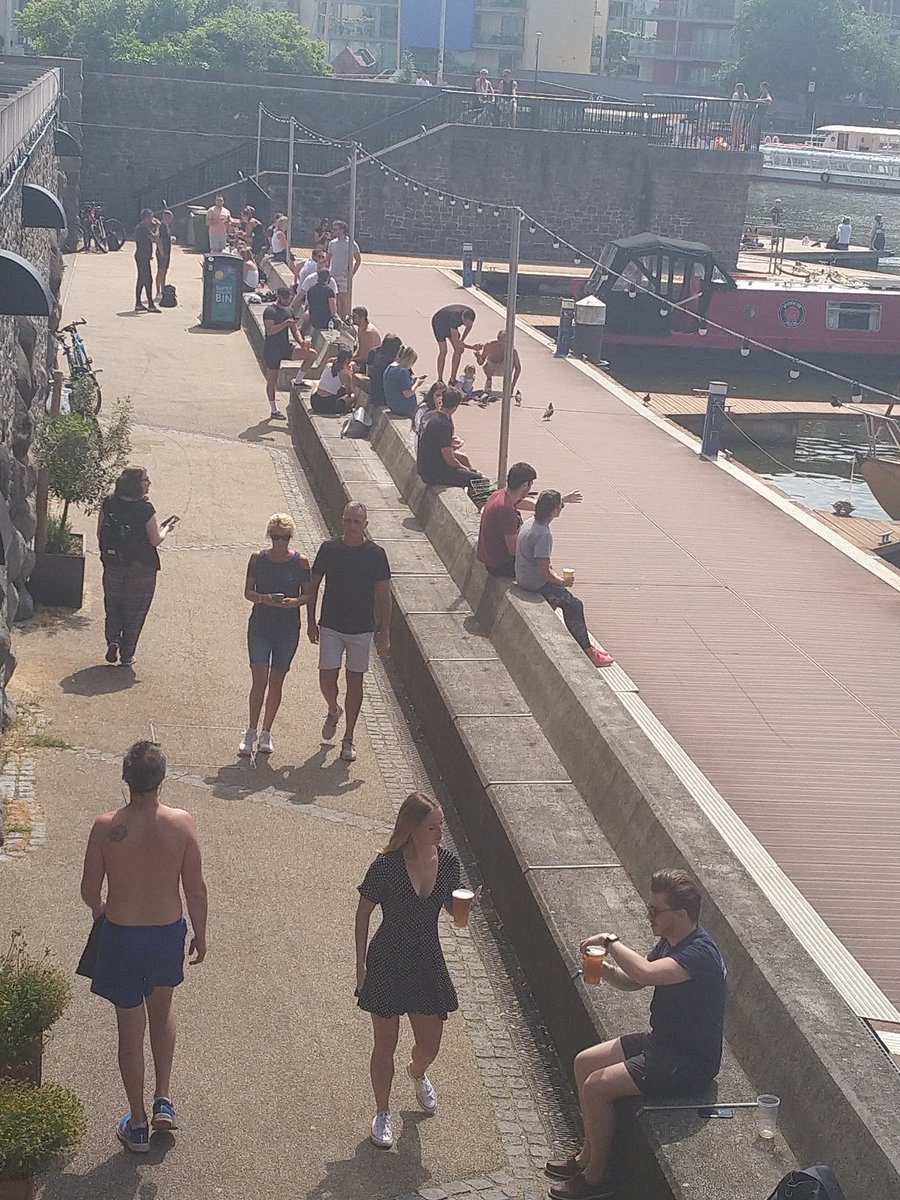 Looks like beer gardens are open again by the harbour, then! So jealous and really want to join in but it's really not the responsible thing. Loads more people round the corner too. 
Some people are queuing for a beer while still drinking previous one.