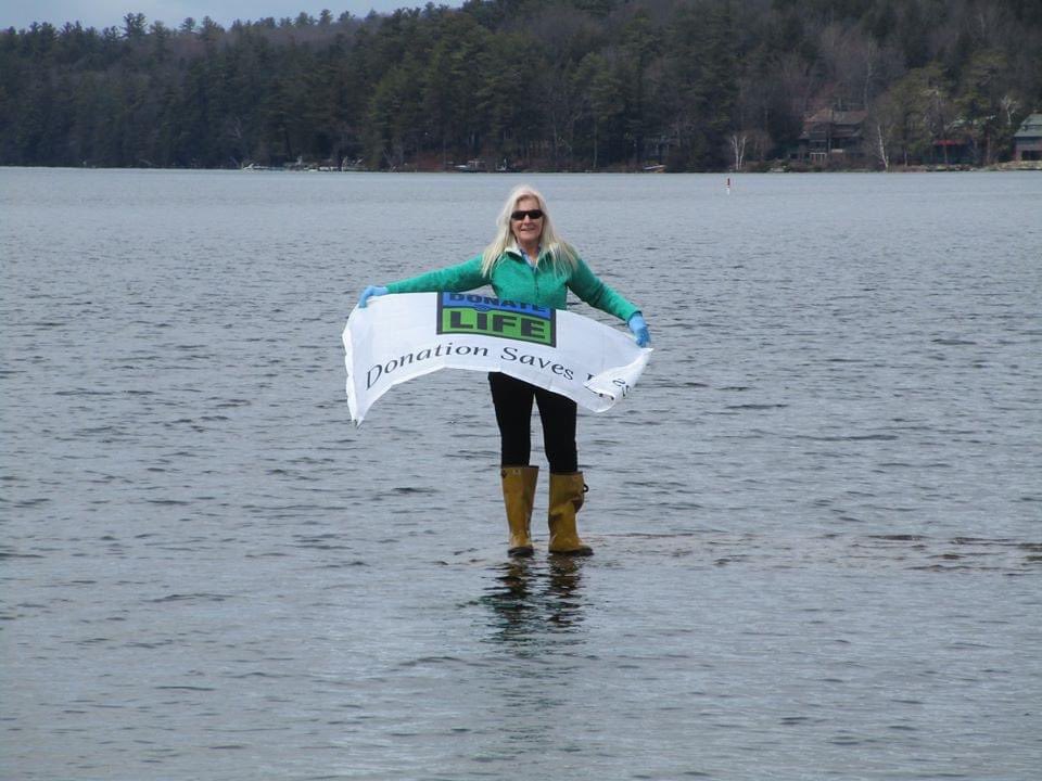 NEDonorServices's tweet photo. It’s no surprise to us that our volunteers walk on water, but how cool are these photos? 🙂💙💚 The water was quite high on May 1 when our volunteer, PJ, lowered the Donate Life flag in Newbury Harbor. #DonateLife #Volunteer #RegisterMe https://t.co/gVGiAdD6Ne