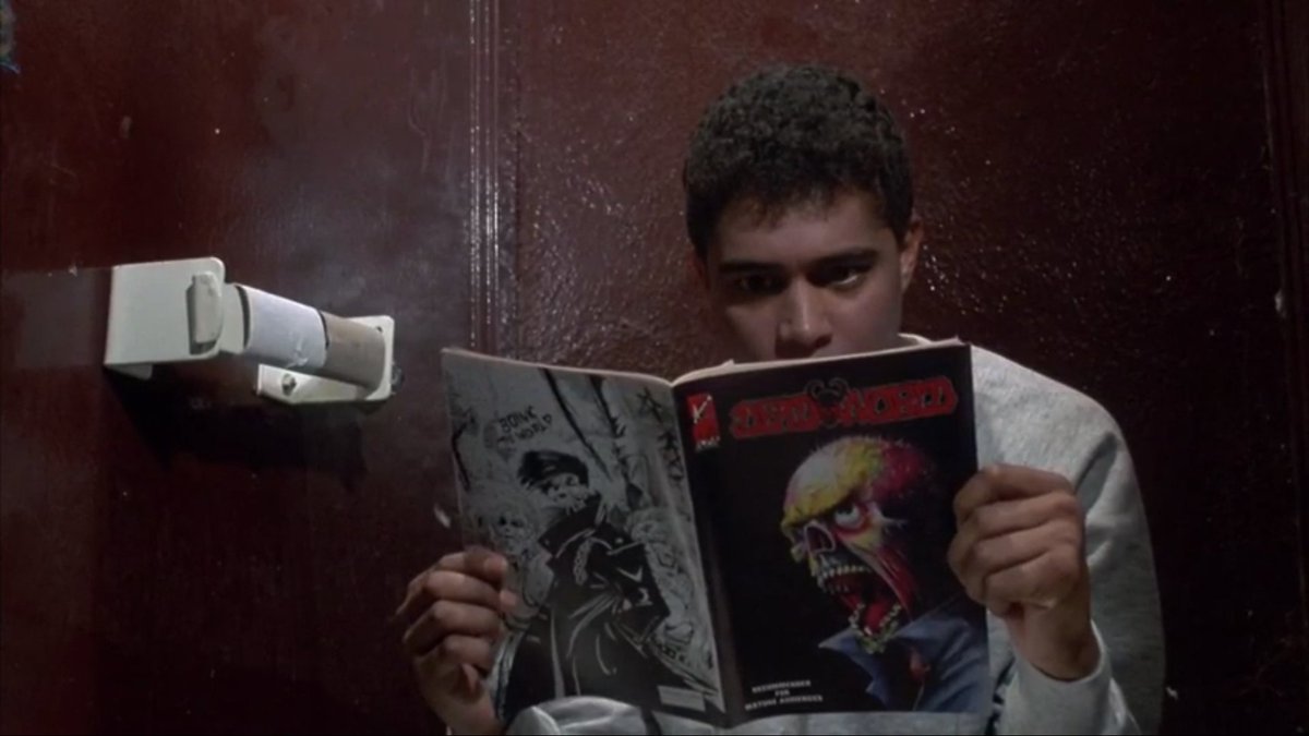 Shudder's tweet photo. The bathroom reading material here is Deadworld, an undead apocalypse comic featuring a smart, talking zombie called, appropriately, King Zombie. #TheLastDriveIn https://t.co/GYwM7dUjLg https://t.co/s2yqRfO8gr