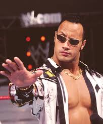 Dewey's wrestling alter-ego "Champ Popular" has sunglasses and a haircut that recall a young "The Rock" Dwayne Johnson during the WWE's late 90s "Attitude Era" period."