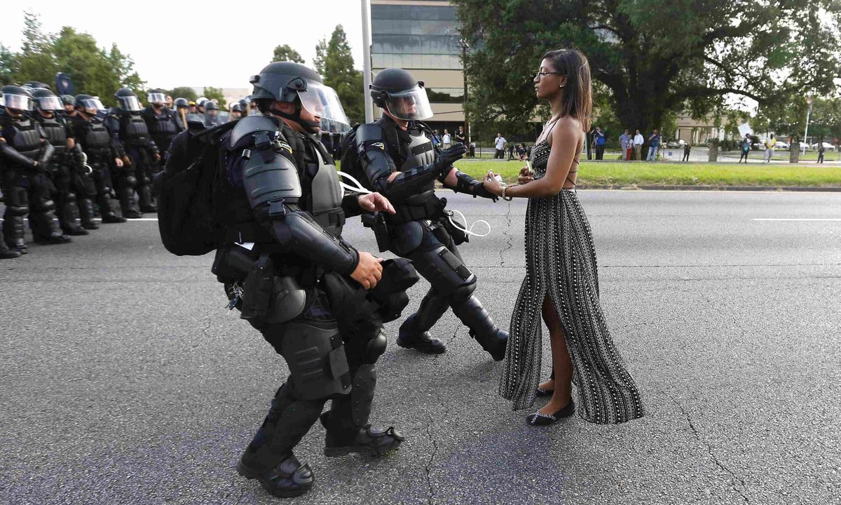 Iesha Evans in Baton Rouge, Louisiana, July 2016, in the instantly iconic pic by Jonathan Bachman. The ludicrously fashy stormtroopers about to arrest her are supposedly “police”.   #resist  #AltonSterling  #BlackLivesMatter  