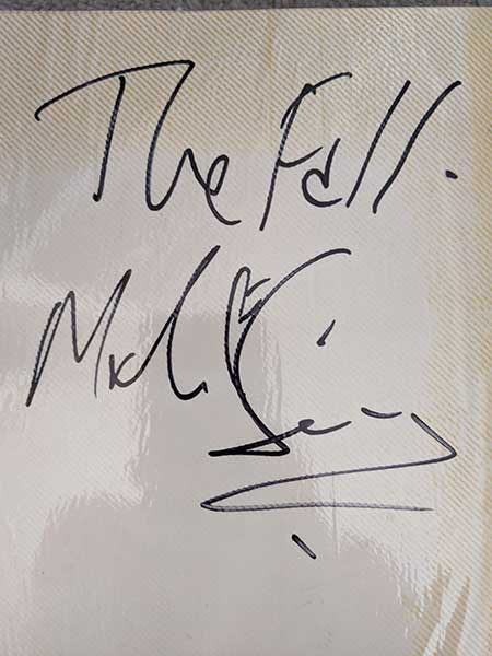 Mark E. Smith's signature. I don't know why there's no picture. He was brought into the station by DJ David Bates, who worked at his then-label, Fontana. David had a Vietnam-era themed show and would dress the studio in cargo netting to get in the mood. 17/19