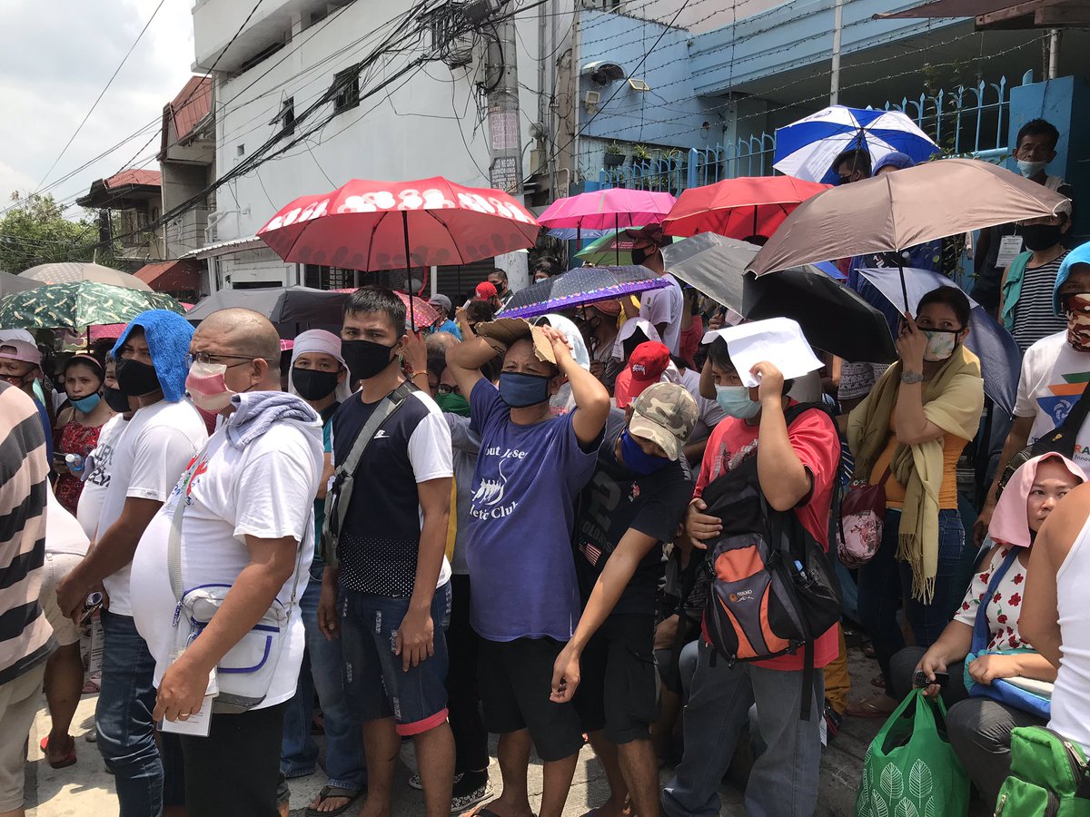 LOOK: People have been queuing up for the first tranche of the government’s cash aid program. Social distancing protocols have not been observed in the queue |  @cnnphilippines