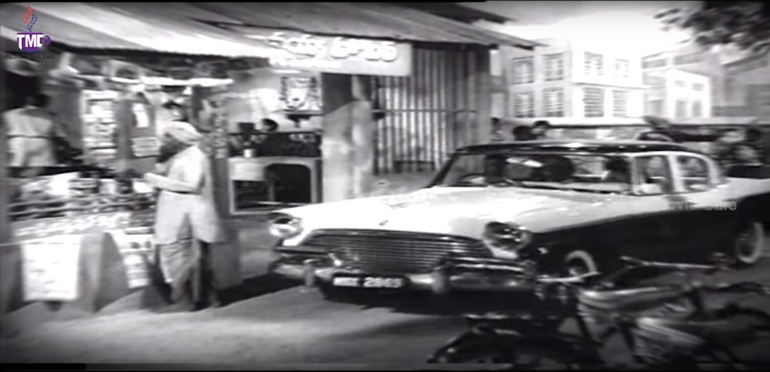 Gummadi and Saroja Devi coming to meet NTR at his cafe in a two-tone 1956 Studebaker President four-door sedan(Dagudu Moothalu, 1964)