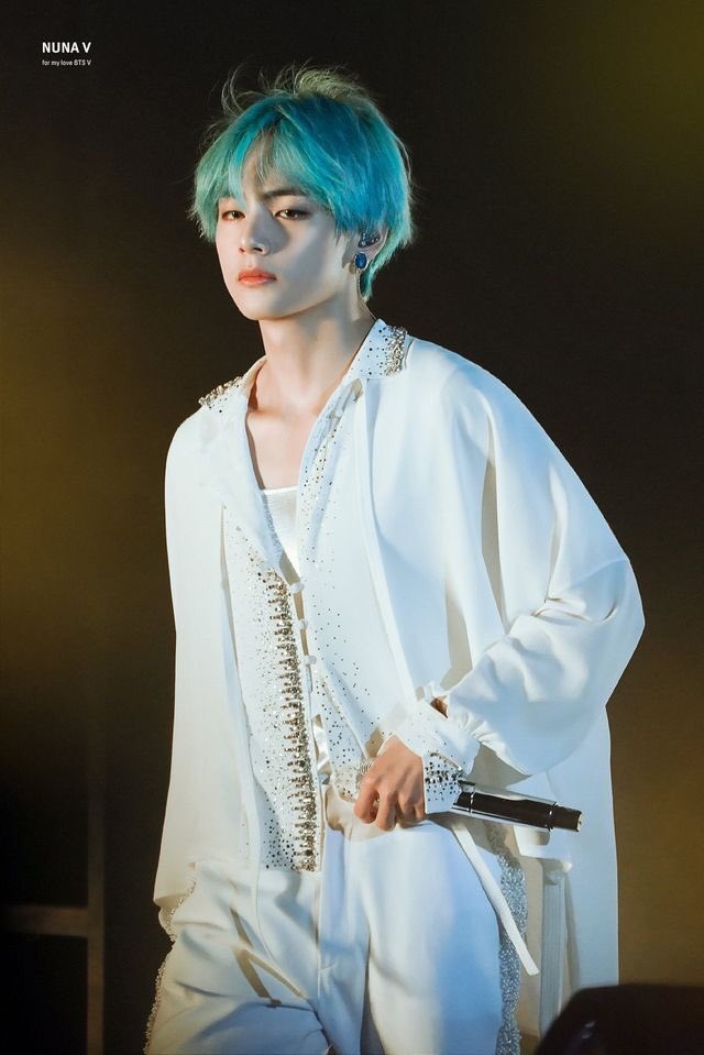 in his bluish-green hair...