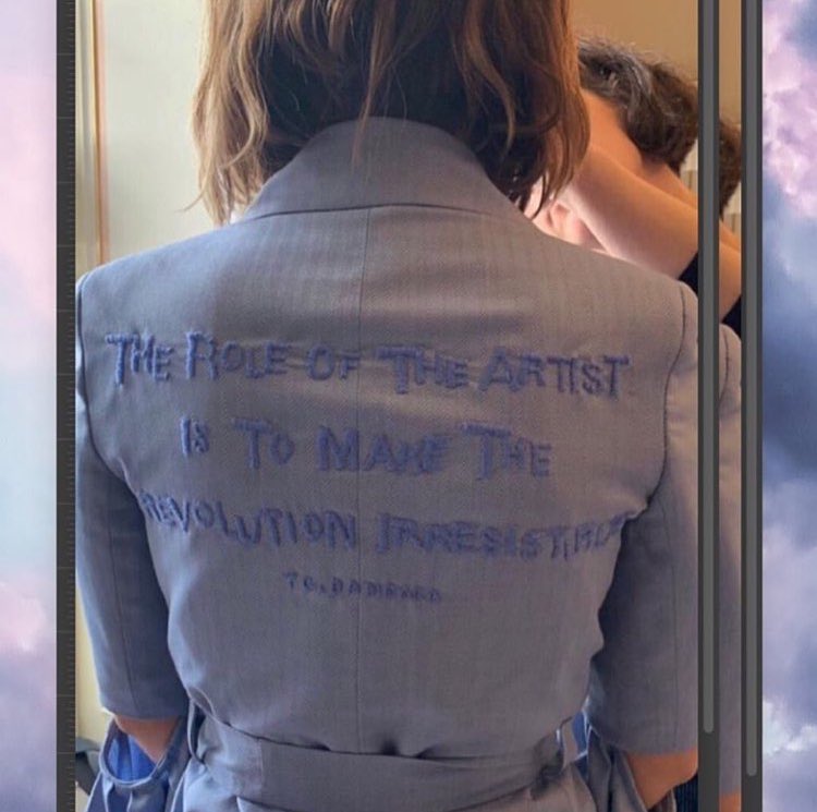 helpwithemma's tweet photo. On the 2019 Gender Equality Conference in France, @EmmaWatson wore a beautiful @TEATUMJONES piece with a quote from Toni Cade Bambara in her back.  
Both the “Emma” blazer and the Lyndon trouser are made from cornflower blue herringbone wool sourced from dead stock fabric mill. https://t.co/M7TnN2e2ws