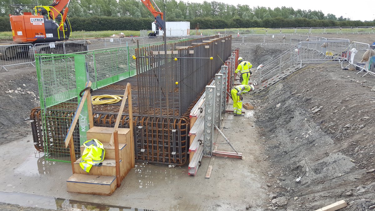 There are two abutments (walls) to the bridge - the shutters to the pilecaps are built once rebar complete. The shutters act as the mould for the concrete until the concrete cures. Long straight bars are starter bars for the abutment wall (good connections as mentioned for BN25)