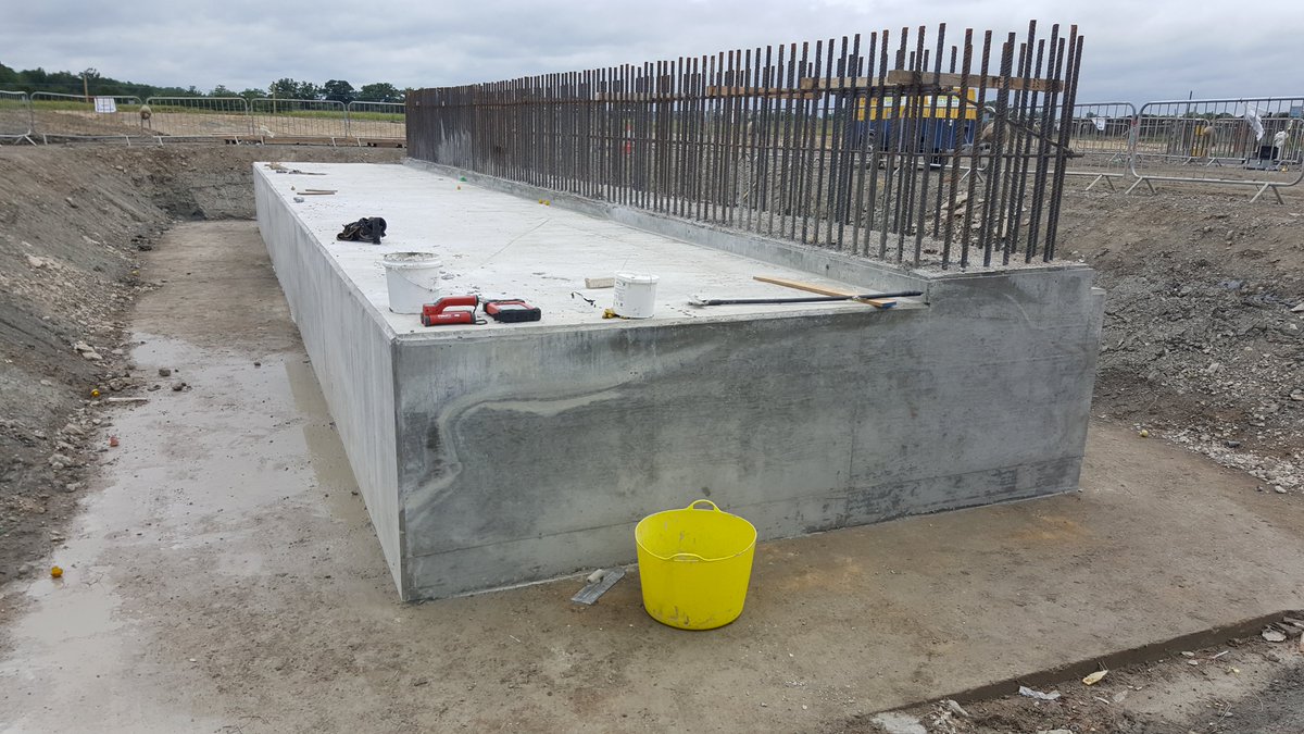 The concrete is poured and shutters removed, leaving starter bars ready for the wall - bridge span is on right, the weight of backfill will sit on the slab top on left on reduce moment (rotating) forces. 35/