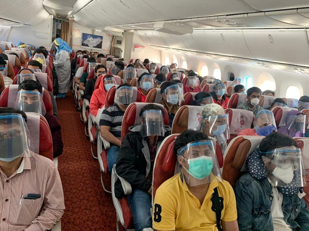 #IndiaFightsCorona: 

Prevention measures are the new normal. 

An image 👇 of passengers wearing face shields while coming back to India in one of the evacuation flights under #VandeBharatMission. 

Via <a href="/HardeepSPuri/">Hardeep Singh Puri</a>
