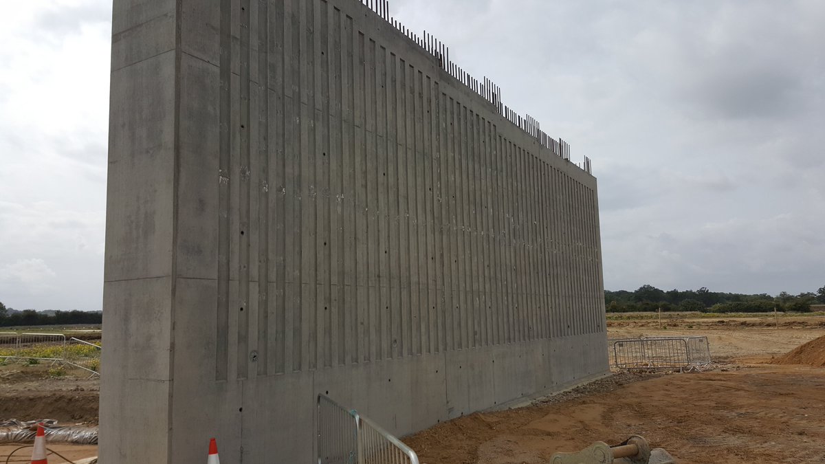 Concrete is poured and after curing the shutters are removed - feature groove to discourage graffiti. Rebar at top is the starter bars for the deck. See the top of wall is stepped? This for the beams which sit at different levels due to camber of the A14 slip road 41/