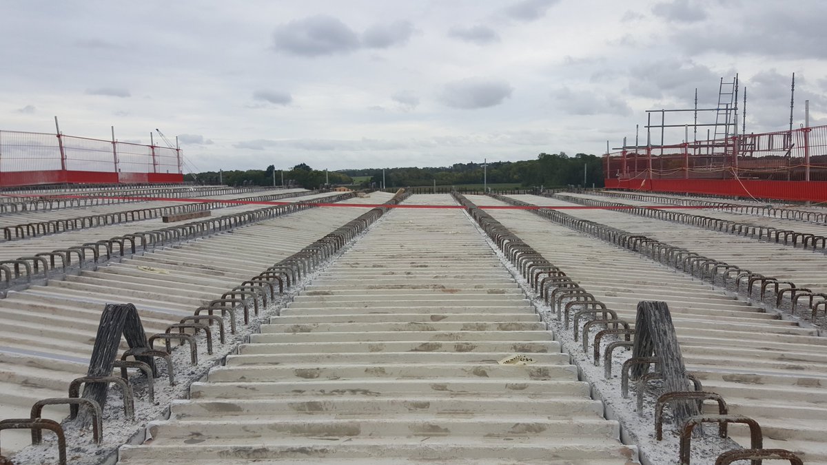 Next on the beams are the grey panels made of glass-reinforced plastic fibres, they form the soffit to the deck, concrete will be placed on this. The small hoops of rebar are shear links that connect the bridge beams to the deck. The two pointy strands are lifting points 44/