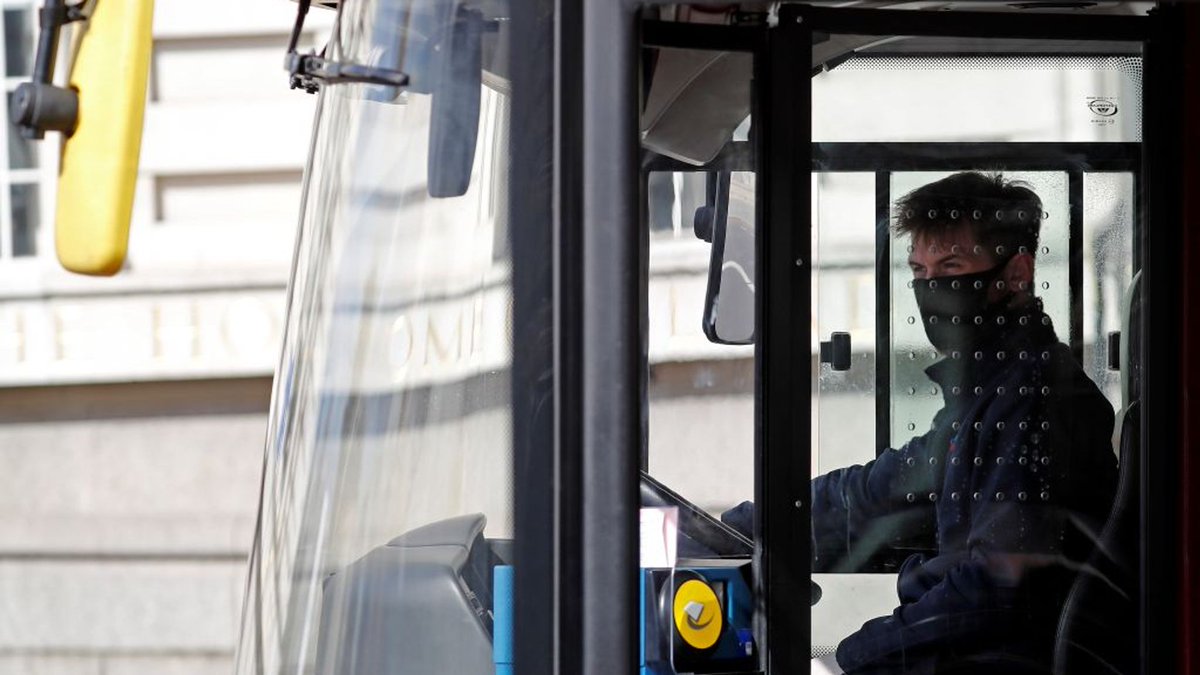 London bus drivers sit in enclosed cab, behind a plastic screen with holes. They can also ventilate their cab by opening their window. Passengers don't generally sit or stand close to them for a prolonged period of time. 6/10
