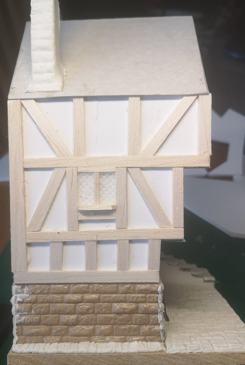 Lack of sleep last night, I don't have a painting brain today, but I can just about deal with sticking balsa wood to the Inn It's starting to look proper now & I'm making the windows as I go. I'm using plastic cross-stitch grid to replicate the leading. #warmongers  #ttrpg