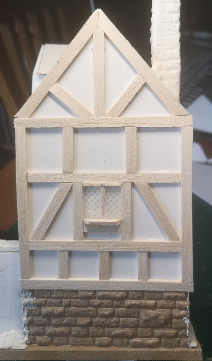 Lack of sleep last night, I don't have a painting brain today, but I can just about deal with sticking balsa wood to the Inn It's starting to look proper now & I'm making the windows as I go. I'm using plastic cross-stitch grid to replicate the leading. #warmongers  #ttrpg