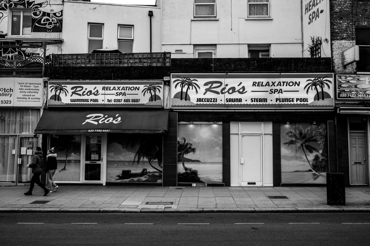 Kentish Town is gritty in the loveliest of times. In lockdown, nearly everything is closed, many shops are boarded up and the high street is pretty empty. Rio’s naturalist spa naturally deserted. Only the fruit and veg fella is happily trading.  https://www.instagram.com/sebastianepayne 