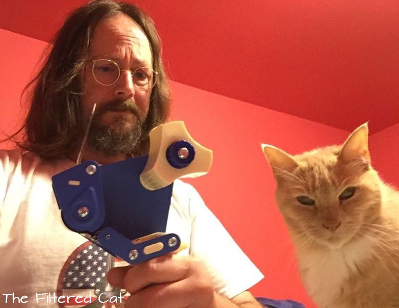 FilteredCat's tweet image. Some years ago, when my hair was long, and my beard was mostly brown, and before Milo became an old geezer of a cat, I ran out of tape. #CatsOnTwitter #cats #MondayFunday #CatsOfTheQuarantine #CatsOfTwitter #meowfeature #yourcatphoto