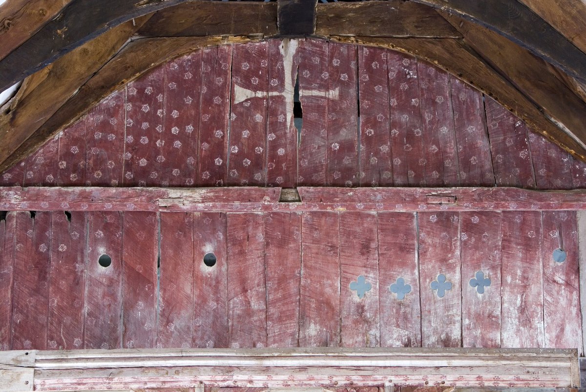 The screen dominates the interior at Llanelieu. It was carved in the 14th century and painted with ox’s blood. The red is peppered with stencilled white roses. In the centre, a cross is picked out in bare wood- a reminder of the crucifix that was lost during the Reformation.2/7