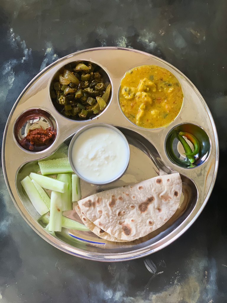 Sometimes all it takes is to put the lunch in a thaali to feel better about it. BhindiGatteDahiRotiKheeraAcharHari mirch.Middle of the working day with no nap in sight 
