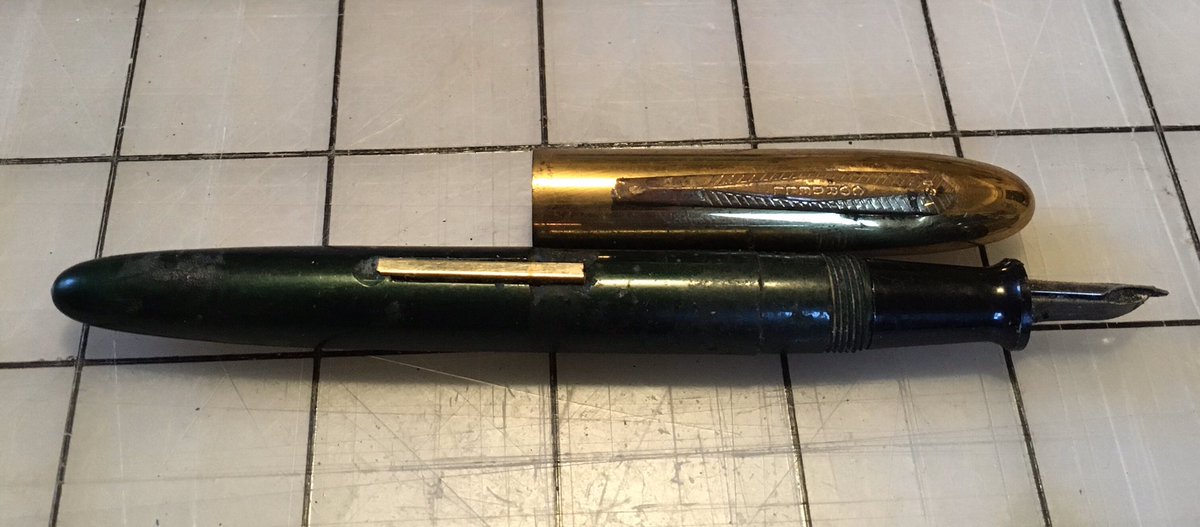 The pen is a c. 1930 Cordell fountain pen. It had some surface ashy residue which wiped clean with a dry cloth and a firm hand, but took zero force to remove fully and reveal a deep glossy pine green. The gold-tone cap fits smoothly.