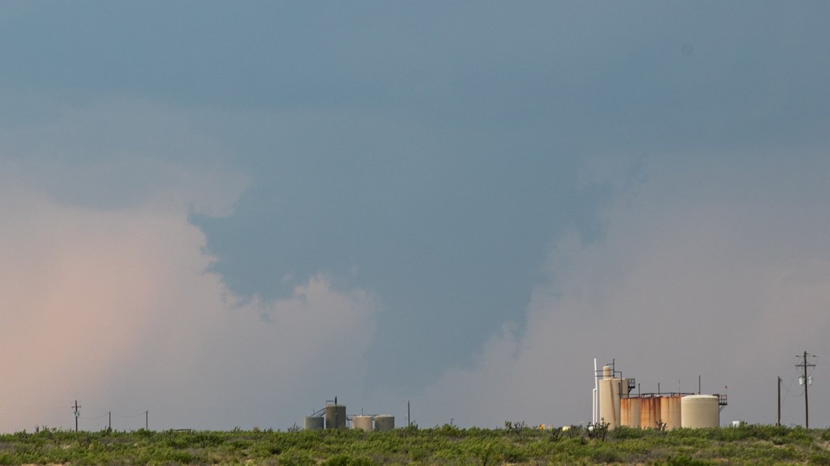 553pm MST After driving west directly into the sun, I finally roll under an anvil. Egads! It looks like there's already circulation! Scud bomb? A funnel? Was it on the ground? I can't be sure... you be the judge.