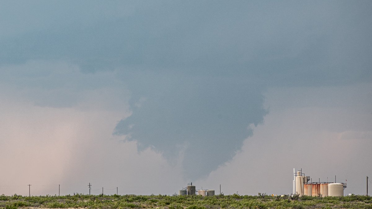 553pm MST After driving west directly into the sun, I finally roll under an anvil. Egads! It looks like there's already circulation! Scud bomb? A funnel? Was it on the ground? I can't be sure... you be the judge.