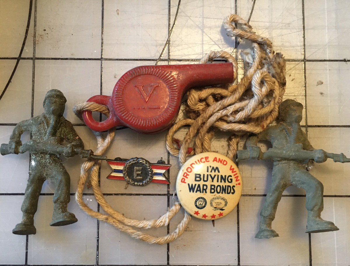 This gives a super clear date range. All these items are WW2 homefront. I haven’t identified the army those toy soldiers in gas masks are part of, but that’s a Victory alert whistle, a war bonds pin, and an “E” pin for excellence in wartime production.