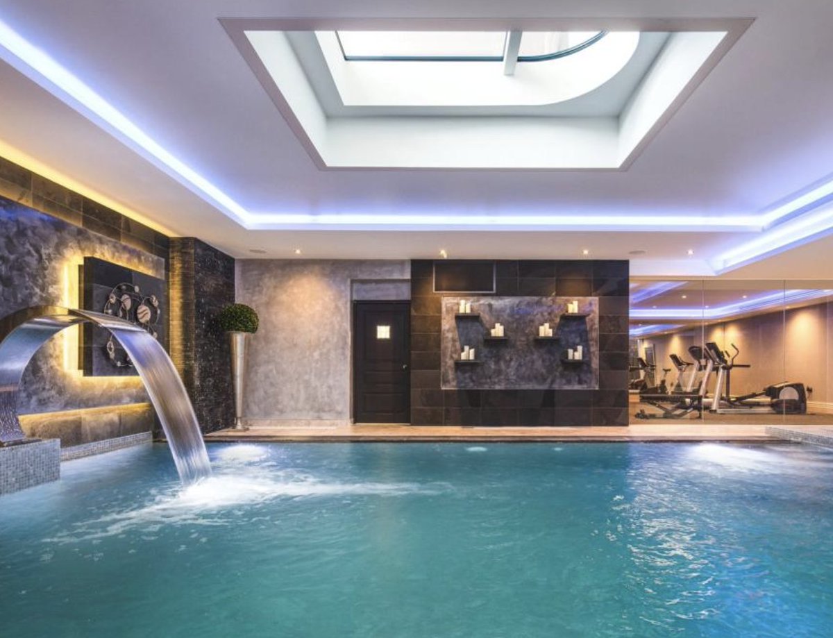 this house is BEAUTIFUL from the outside. but then you notice it has a weird glass panel in the floor of the hallway?? what's below it.. an amazing pool! wow! but what do you do when the Ocado bloke comes and your husband is in the pool below naked? also velour cinema. no.