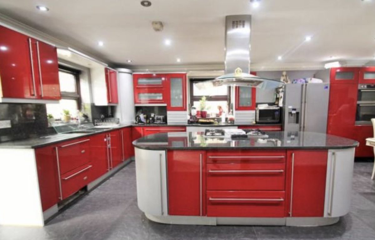 oh this looks quite nice? nice gate, cute house... ARGH RED KITCHEN HOW JARRING!! and why is the toilet.. so far away from the bath?! where does the door go next to the toilet? oh.. and there's a cinnamon swirl in the ceiling of the lounge. sure. why not. sofa looks a bit rigid