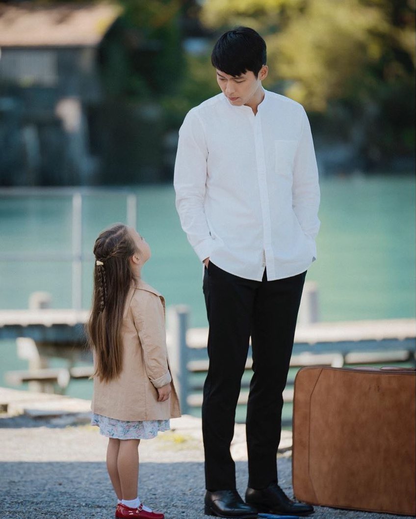 a baby being babied by another baby