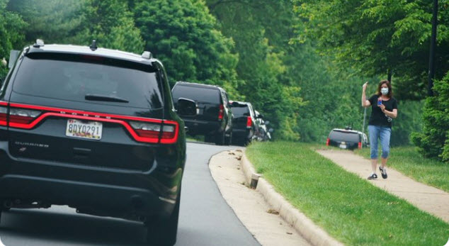 mindys4Biden's tweet photo. I would like to raise my glass to this woman who flipped off trump's motorcade today as he was on his way to his golf course in VA. Cheers! https://t.co/mgH7aTf32L