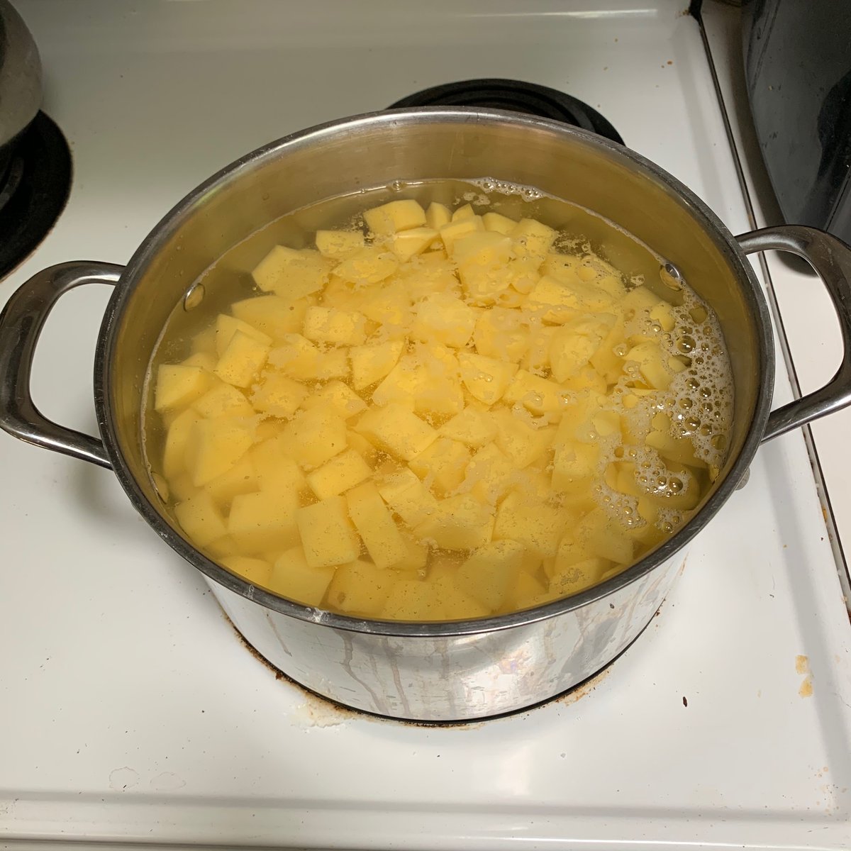 5 lbs gold potatoes, peeled and diced. Even with her arthritis, my mother could've done this in half the time. I remember a cook on one of my wife's cooking shows said to boil potatoes in salty water. I added 10 quick grinds from our salt grinder. ?/