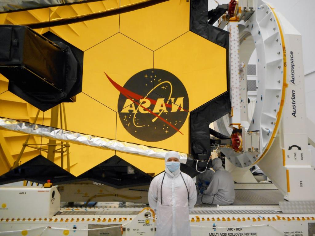 Zao Huang in front of the James Webb Space Telescope.