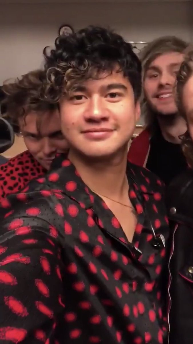 calum hood wearing colourful clothes; a thread