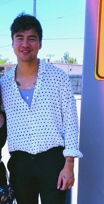 calum hood wearing colourful clothes; a thread