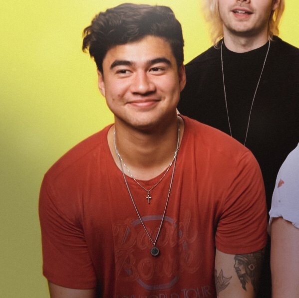 calum hood wearing colourful clothes; a thread