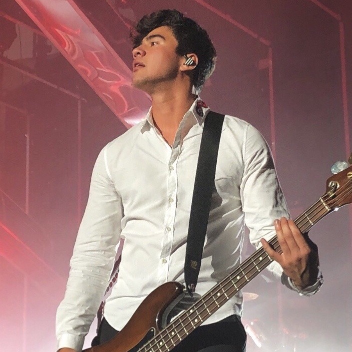 calum hood wearing colourful clothes; a thread