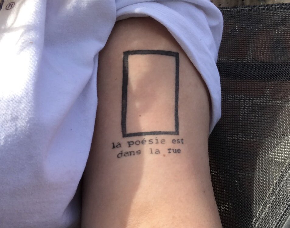 23rd september 2019first real tattoo, the 1975 rectangle with 'la poésie est dans la rue' underneath, 'the poetry is in the streets' also got this on the one year anniversary of meeting my best friends through the 1975 not announcing newcastle on their tour so thank u